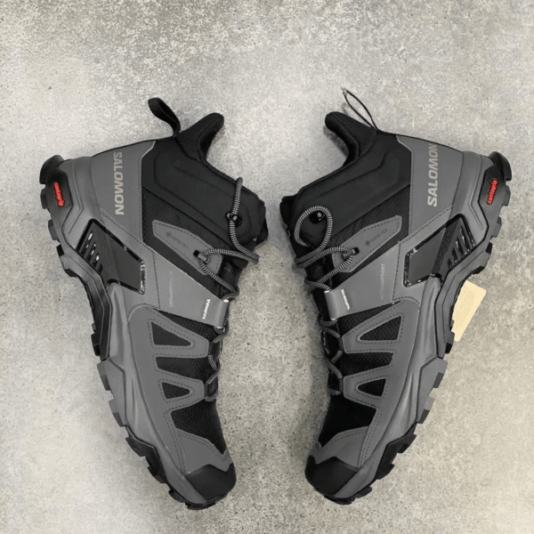 Salomon hiking boot in black and gray, side view with rugged sole