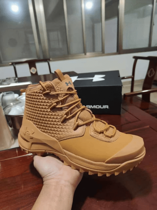 Khaki Base Under Armour hiking boot with rugged sole and breathable upper mesh.